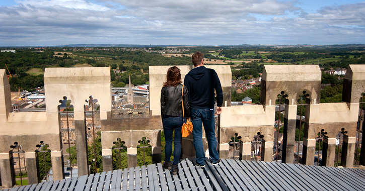 couple looking at view from the top of Durham Cathedral's central tower